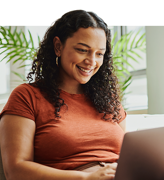 Younger woman looking down at her laptop