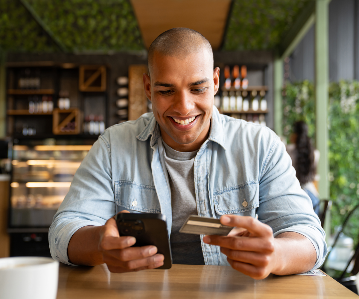 Man holding phone and credit card
